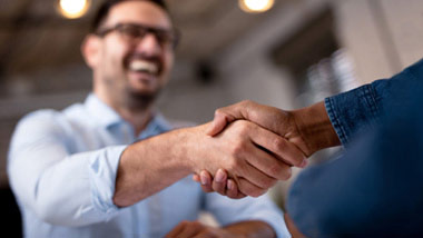 two men shaking hands to close a deal