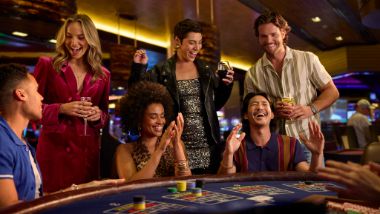 Group of friends smiling while playing baccarat