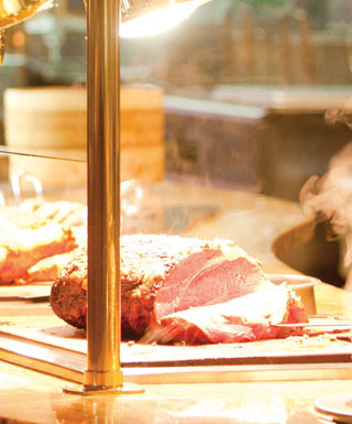 A full ham is sliced at the carving station at Epic Buffet at Hollywood Casino Joliet.