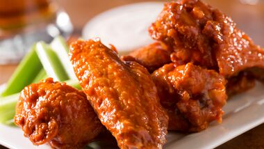 Buffalo chicken wings plated with celery