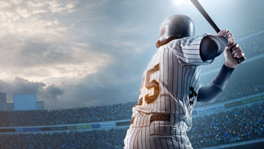 Batter at bat in stadium with glow from stadium lights